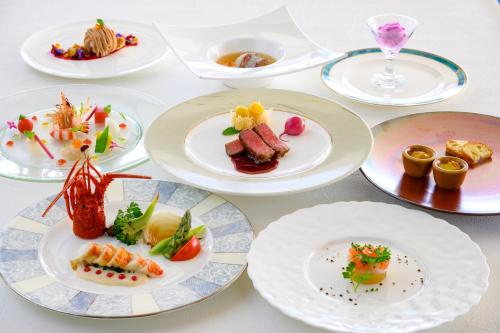 a white table with plates of food on it at Toba International Hotel in Toba