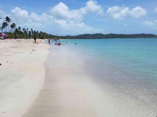 a beach with people swimming in the water at Casa Marino - RELAX just minutes from Beaches in Llanos Tuna