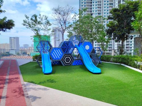 a playground in a park with a blue slide at View of the whole Georgetown in George Town
