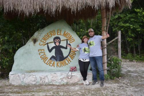 a man and a woman standing in front of a sign at Eco Aldea kinich Ahau in Xpujil