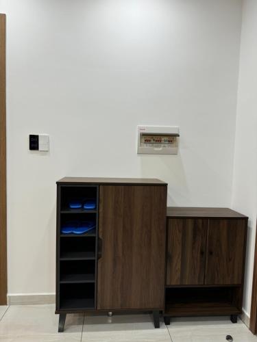 a wooden cabinet with an appliance on a wall at Happy One Central in Ga Phú Văn