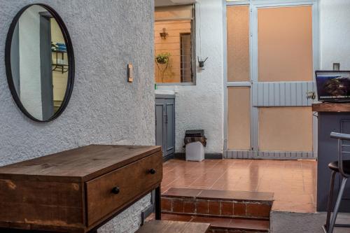 a bathroom with a mirror and a wooden dresser at Sencillo y Acogedor Estudio en Chapalita 02 in Guadalajara