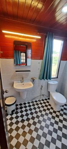 a bathroom with two toilets and a sink at Lucky Bungalow in Khao Lak