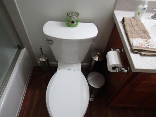 a bathroom with a toilet with a can of soda on it at Couple's Retreat - Get Away to Turtle Bay in Kahuku