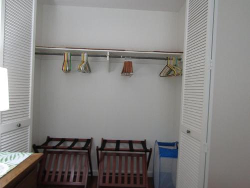two chairs in a closet with baseball bats at Couple's Retreat - Get Away to Turtle Bay in Kahuku