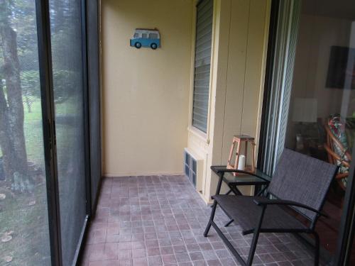 a porch with a chair and a train on the wall at Couple's Retreat - Get Away to Turtle Bay in Kahuku