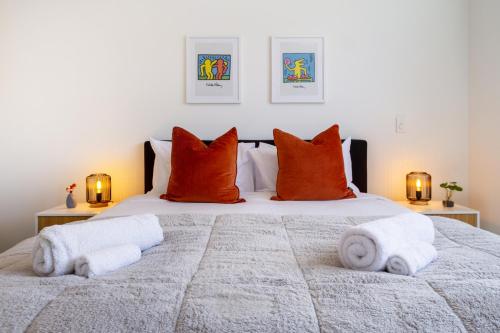 a bedroom with a large bed with towels on it at Bright & Stylish 2BR Near Addington Park in Addington