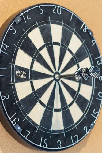 a black and white dartboard clock on a wall at Bright & Stylish 2BR Near Addington Park in Addington