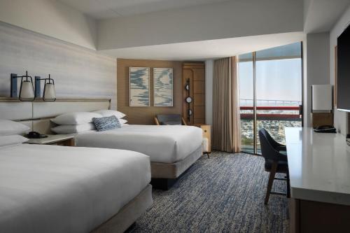 a hotel room with two beds and a desk at Marriott Marquis San Diego Marina in San Diego