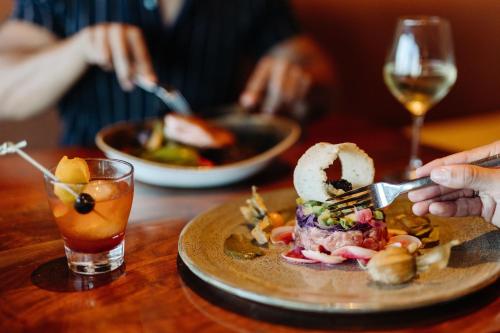 a plate of food on a table with people eating at Marriott Marquis San Diego Marina in San Diego
