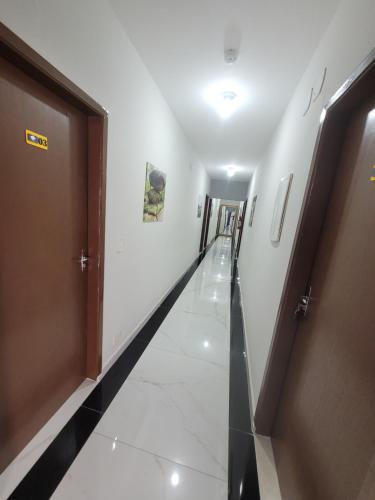 a corridor of a hospital with a hallway at Hospedaria São Benedito in Guararema