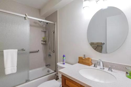 a bathroom with a sink and a shower and a mirror at Couple's Retreat - Get Away to Turtle Bay in Kahuku