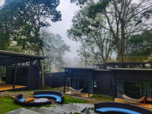 a playground with hammocks in a park with trees at Cabaña V Moderna y Memorable Corotú Garden in Boquete