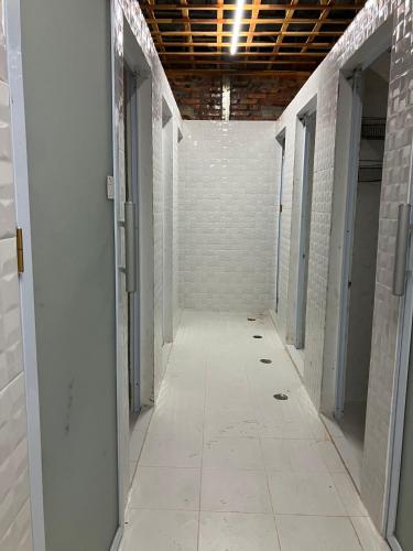 an empty hallway with white brick walls and a ceiling at Venn Hostel in Vientiane