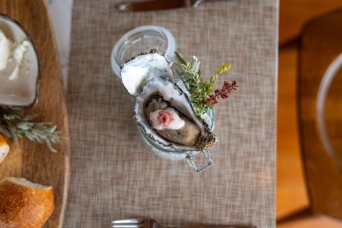 a oyster in a glass dish on a table at The River Suites, Kangaroo Island in American River