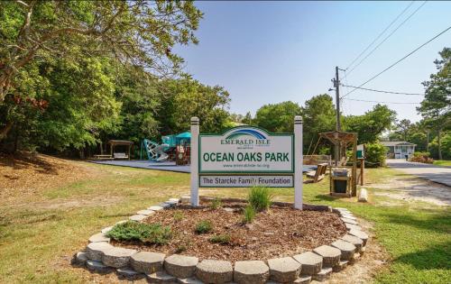a sign for an ocean costs park in a yard at Pink Paradise in Emerald Isle