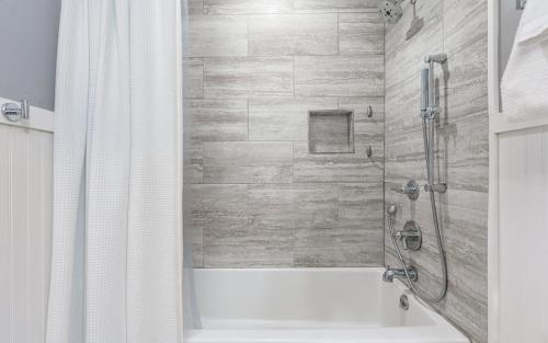 a bathroom with a shower and a bath tub at Cottage On The Ridge in Sevierville