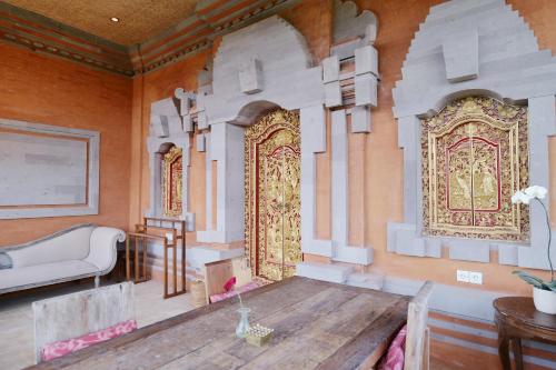 a room with a large door in the wall at Gayatri in Ubud