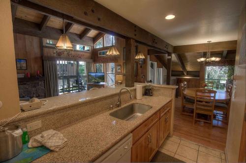 a kitchen with a sink and a dining room at Bear Lake Hideaway condo in South Lake Tahoe