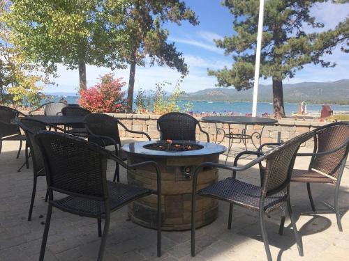 a group of tables and chairs with the beach in the background at Bear Lake Hideaway condo in South Lake Tahoe