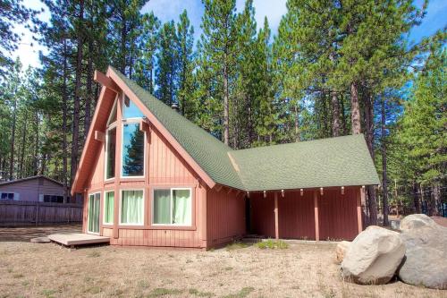 a small red house with a green roof at Snowshoe Chalet cabin in South Lake Tahoe