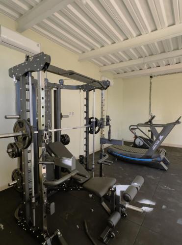 a gym with two tread machines and a treadmill at VILLA IPSA in Munduk
