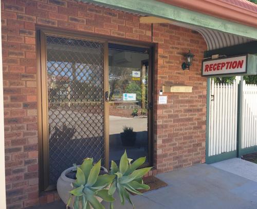 a entrance to a restaurant with a sign on the door at The Finley Palm Motor Inn in Finley