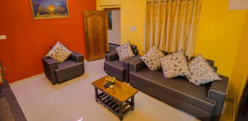 a living room with two couches and a coffee table at S V IDEAL HOMESTAY -2BHK SERVICE APARTMENTS-AC Bedrooms, Premium Amities, 2KM to Tiruchanoor Padmavathi Temple , 6KM to Alipiri, 24 HOURS Service BOYS Available in Tirupati