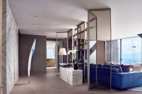 a living room with a blue couch and a surfboard at The Ritz-Carlton, Mexico City in Mexico City
