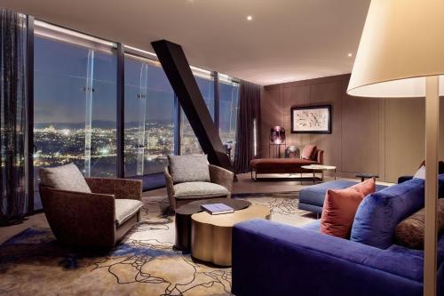 a living room with a blue couch and chairs at The Ritz-Carlton, Mexico City in Mexico City