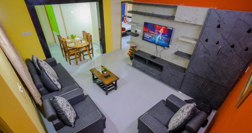 an overhead view of a living room with a tv at S V IDEAL HOMESTAY -2BHK SERVICE APARTMENTS-AC Bedrooms, Premium Amities, 2KM to Tiruchanoor Padmavathi Temple , 6KM to Alipiri, 24 HOURS Service BOYS Available in Tirupati