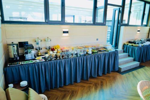 a long blue table with food on it in a room at RIO Hotel in Samarkand