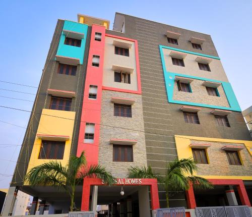 a tall building with colorful windows on the side of it at S V IDEAL HOMESTAY -2BHK SERVICE APARTMENTS-AC Bedrooms, Premium Amities, 2KM to Tiruchanoor Padmavathi Temple , 6KM to Alipiri, 24 HOURS Service BOYS Available in Tirupati