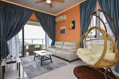 a living room with a couch and a swing at Country Garden Seaview Suite by Nest Home at Danga Bay in Johor Bahru