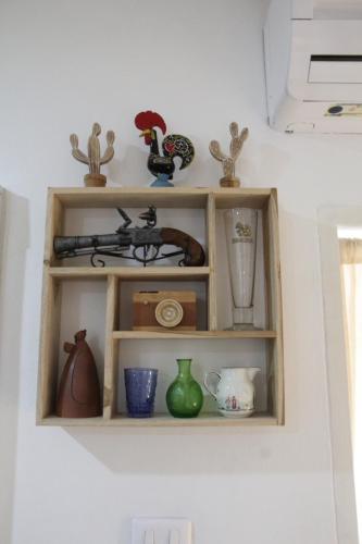 a shelf with various items on it on a wall at Homeku Guesthouse Room 2 near airport at Latkrabang in Lat Krabang