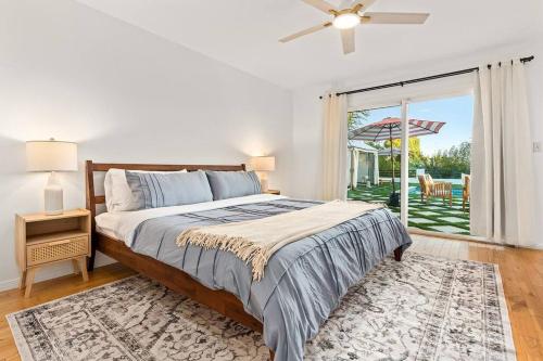 a bedroom with a bed and a sliding glass door at Luxury 4BD and 3BA in Topanga Oasis with Pool, Spa and Cabana in Glenview