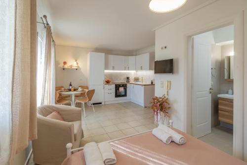 a living room with a table and a kitchen at il Dolcino Central Studio - Apartment Kefalonia in Argostoli