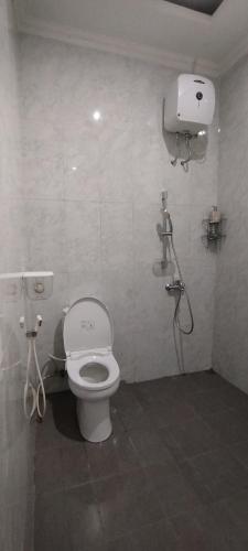 a bathroom with a toilet and a shower at Zavira House Purwokerto in Purwokerto