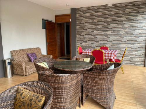 a living room with a table and chairs at Royal Residency in Plaine Magnien