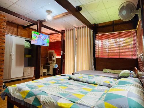 a bedroom with a bed and a flat screen tv at Cát Tiên Riverside in Tân Phú