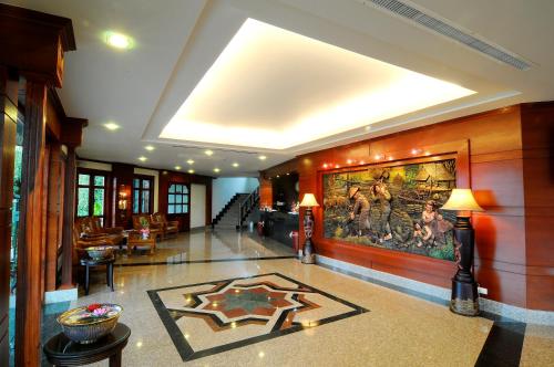 a lobby with a large painting on the wall at Busyarin Hotel in Nong Khai