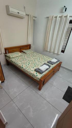 a small bed in a room with at Krishnarpanam 2BHK villa in Guruvayoor- only for families in Guruvāyūr