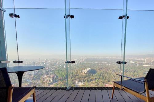 a view from the top of a building with a table and chairs at The Ritz-Carlton, Mexico City in Mexico City