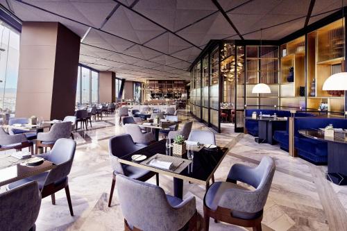 a restaurant with tables and chairs and a bar at The Ritz-Carlton, Mexico City in Mexico City