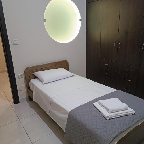 a small bedroom with a bed and a lamp at Drosoula house in Chania Town