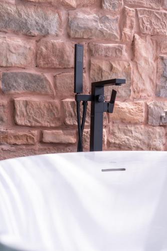 a microphone on a table in front of a brick wall at Sangthian Beach Resort in Ko Samed