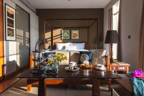 a living room with a bed and a coffee table at Taj Chia Kutir Resort & Spa Darjeeling in Darjeeling