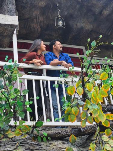 a group of people sitting on a bench at S & B Dreams House in Munnar