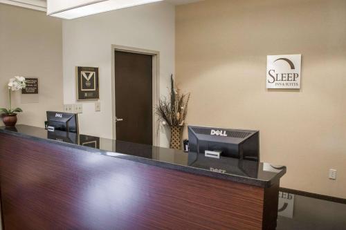 an office with a desk with a sign on the wall at Sleep Inn & Suites Harbour Pointe in Brandermill
