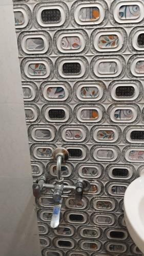 a bathroom with a wall with a bunch of pipes at Decent furnished 1RK Navi Mumbai in Taloje
